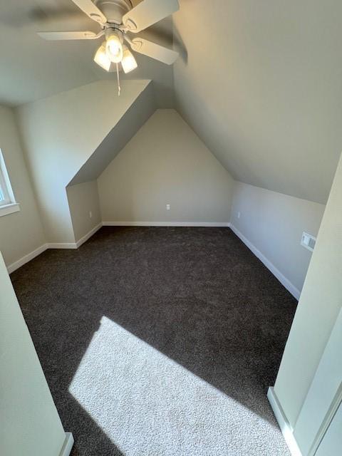 bonus room featuring vaulted ceiling, a ceiling fan, baseboards, and carpet floors