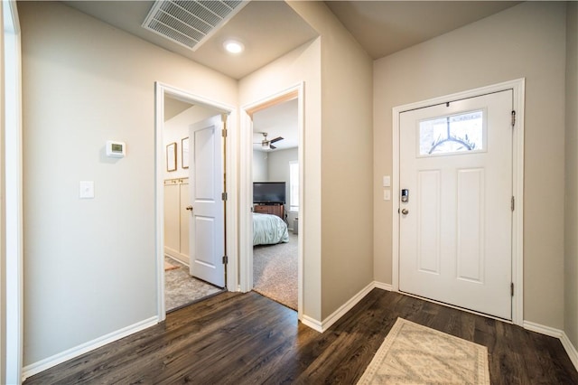 entryway with ceiling fan and dark wood-type flooring