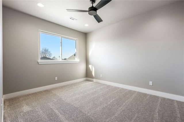 carpeted spare room with ceiling fan