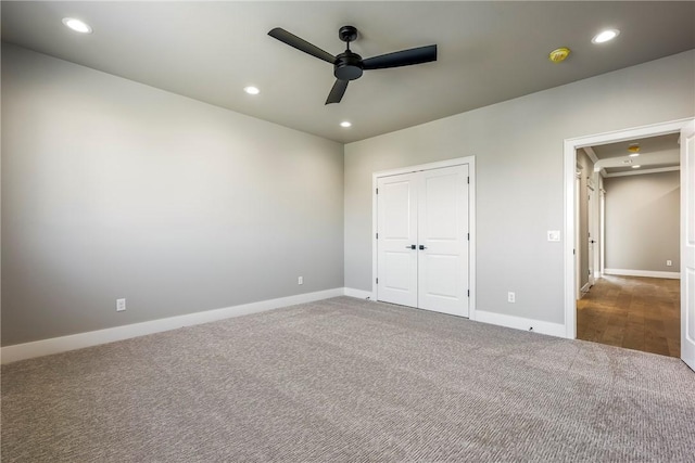 unfurnished bedroom featuring ceiling fan, a closet, and carpet floors