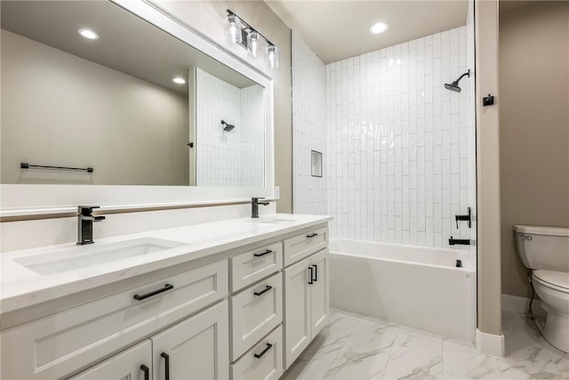 full bathroom with toilet, tiled shower / bath combo, and vanity