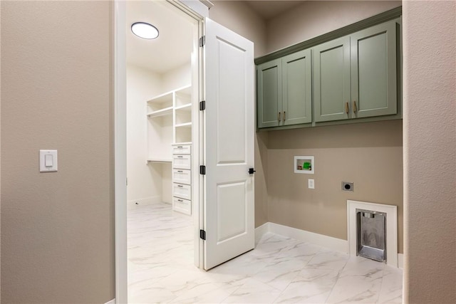 washroom with washer hookup, electric dryer hookup, and cabinets