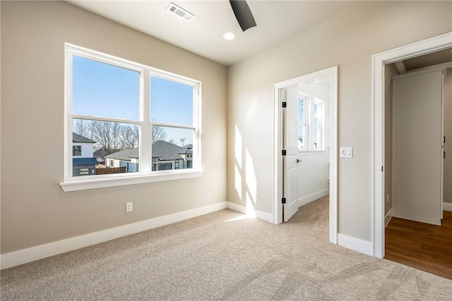 unfurnished bedroom featuring ceiling fan, a closet, and light carpet