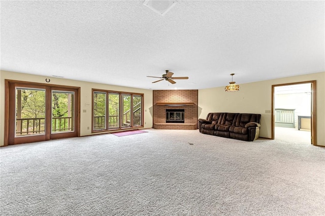 carpeted living room featuring ceiling fan, a fireplace, and a textured ceiling