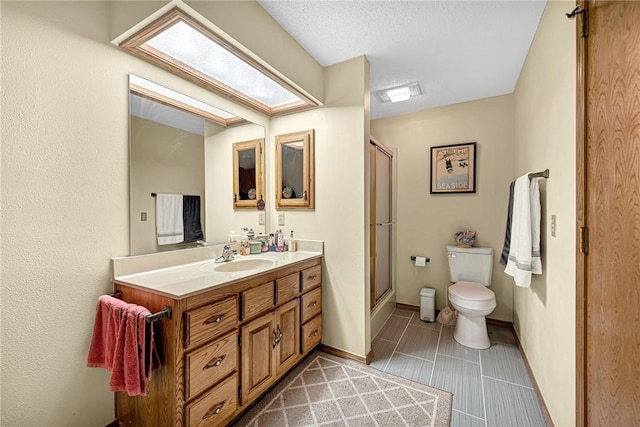 bathroom with toilet, a shower with shower door, a textured ceiling, vanity, and tile patterned flooring