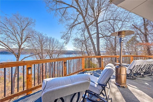 wooden terrace featuring a water view