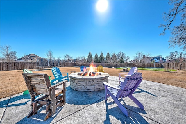 view of patio featuring an outdoor fire pit and a trampoline