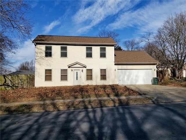 colonial-style house featuring central AC unit and a garage