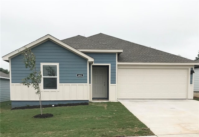 view of front of house with a garage and a front yard