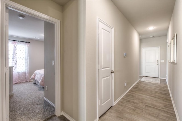 corridor featuring light colored carpet