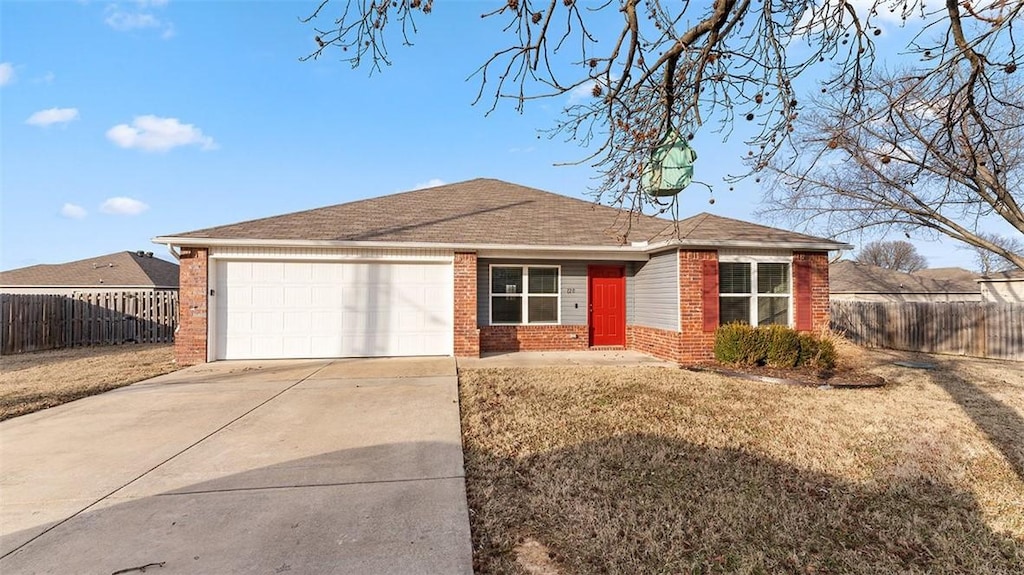 ranch-style house with a garage and a front yard