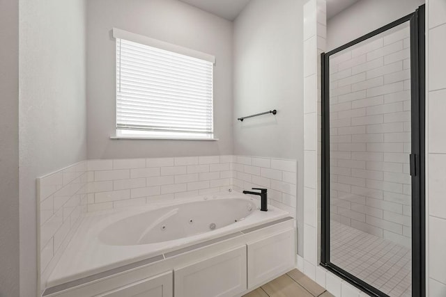 bathroom with independent shower and bath and tile patterned floors