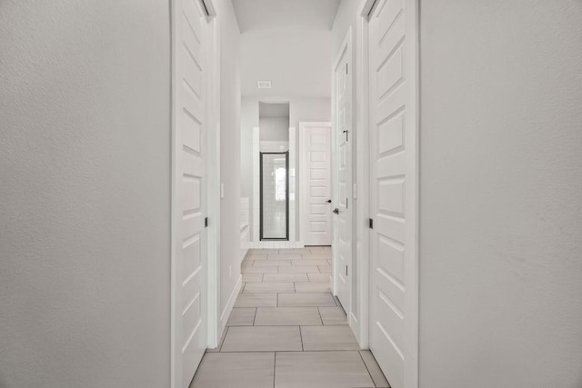 hall featuring light tile patterned floors