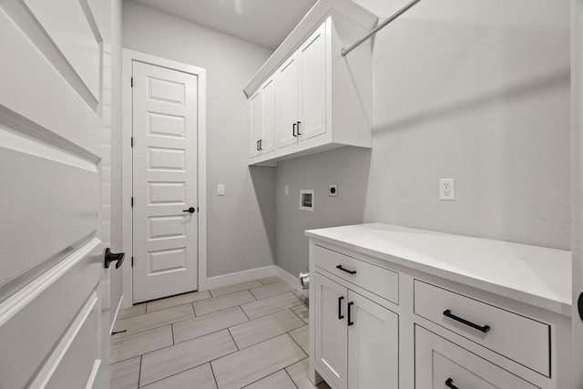 washroom featuring hookup for a washing machine, electric dryer hookup, and cabinets