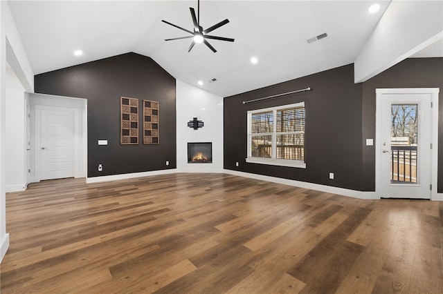29 Shanklin Dr, Bella Vista, AR 72715 - unfurnished living room featuring ceiling fan, healthy amount of natural light, wood finished floors, a large fireplace, and high vaulted ceiling