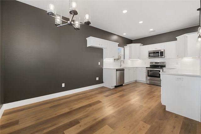29 Shanklin Dr, Bella Vista, AR 72715 - kitchen featuring stainless steel appliances, a chandelier, recessed lighting, backsplash, and light countertops