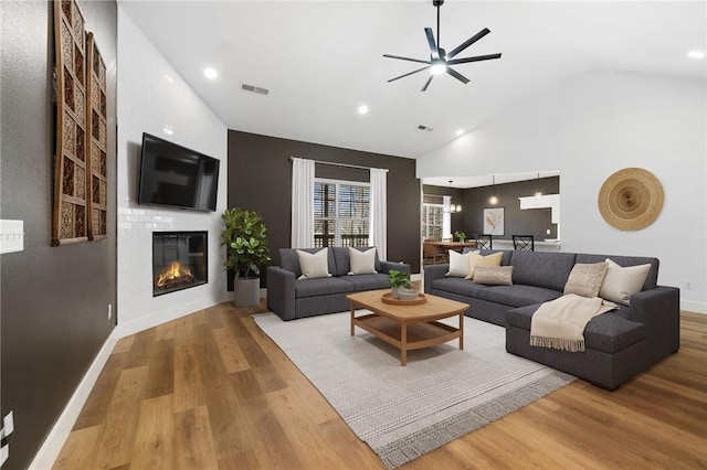 29 Shanklin Dr, Bella Vista, AR 72715 - living room with ceiling fan, a fireplace, wood finished floors, recessed lighting, and high vaulted ceiling