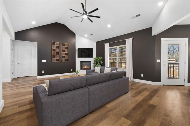 29 Shanklin Dr, Bella Vista, AR 72715 - living area featuring a ceiling fan, a glass covered fireplace, wood finished floors, high vaulted ceiling, and recessed lighting