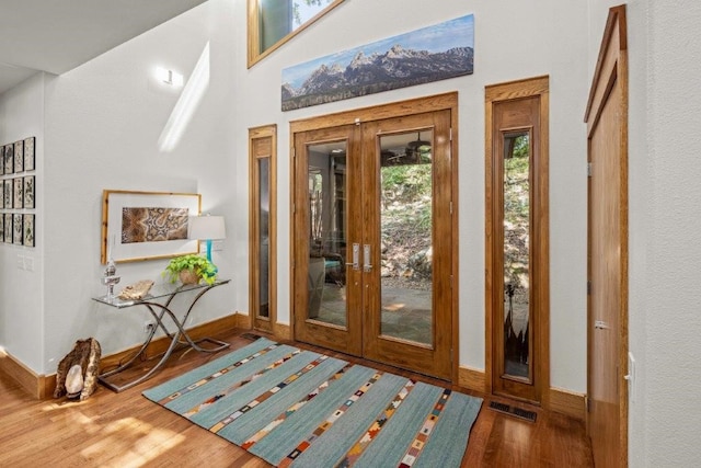 doorway to outside with wood-type flooring and french doors