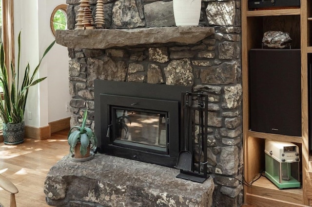 interior details featuring wood-type flooring and a fireplace