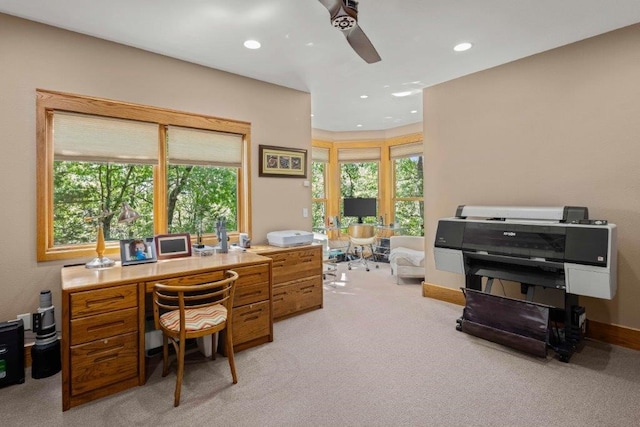 carpeted home office featuring ceiling fan