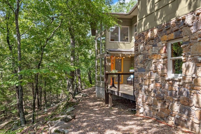 view of side of home with a wooden deck