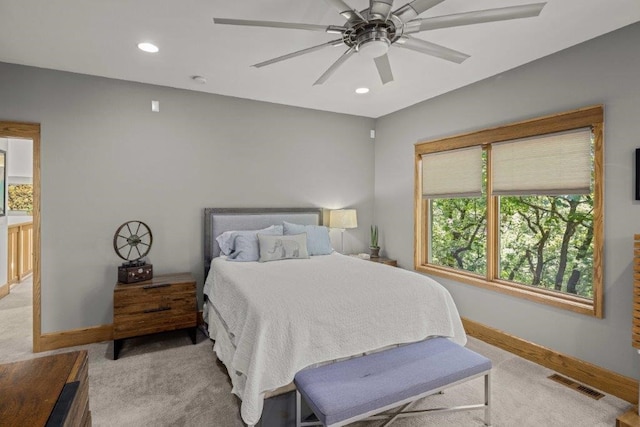 bedroom featuring ceiling fan and light carpet