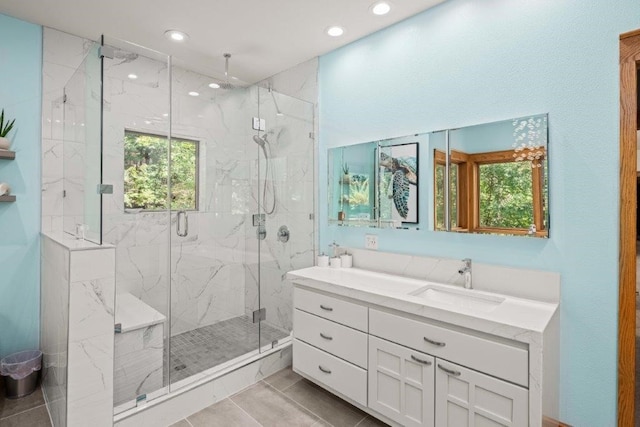 bathroom featuring vanity, tile patterned floors, and a shower with door