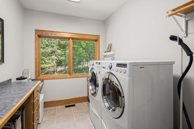 laundry room with light tile patterned flooring and washer and clothes dryer