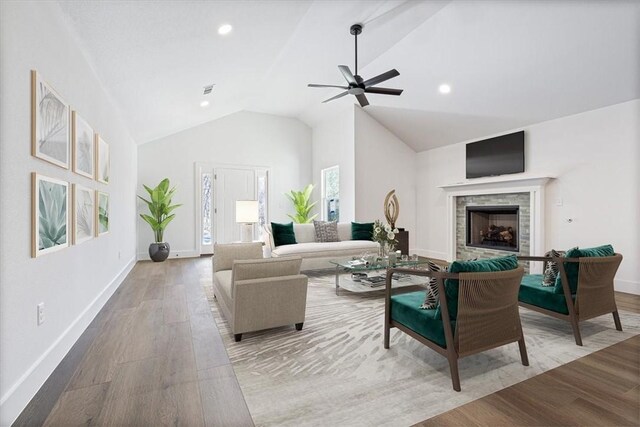 living room with light wood-type flooring, vaulted ceiling, and ceiling fan