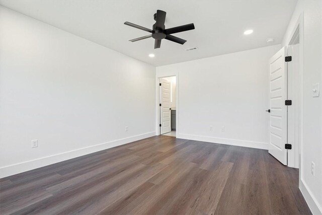 empty room featuring ceiling fan and dark hardwood / wood-style flooring