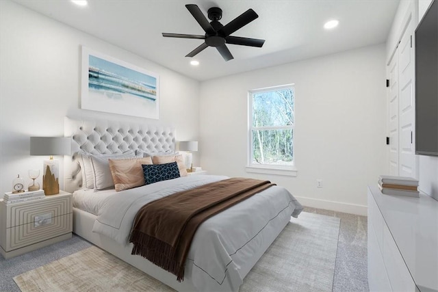 carpeted bedroom featuring ceiling fan and a closet