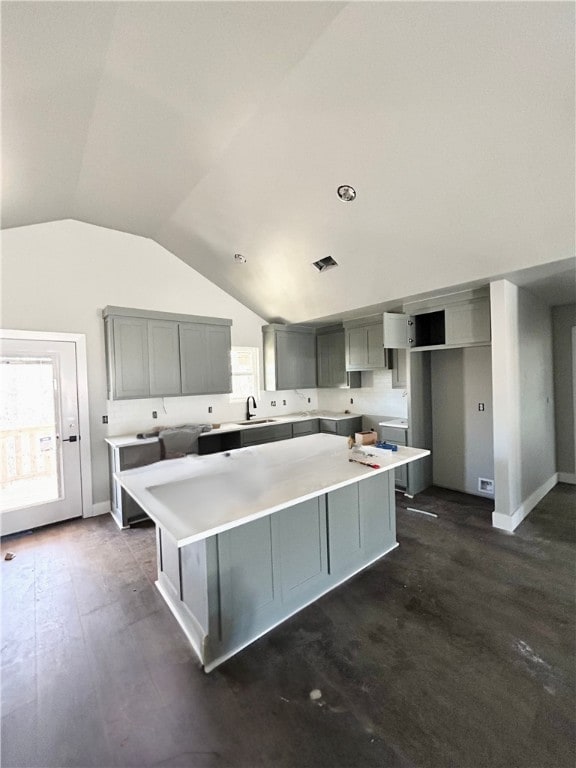 kitchen with sink, gray cabinetry, dark hardwood / wood-style floors, and a center island