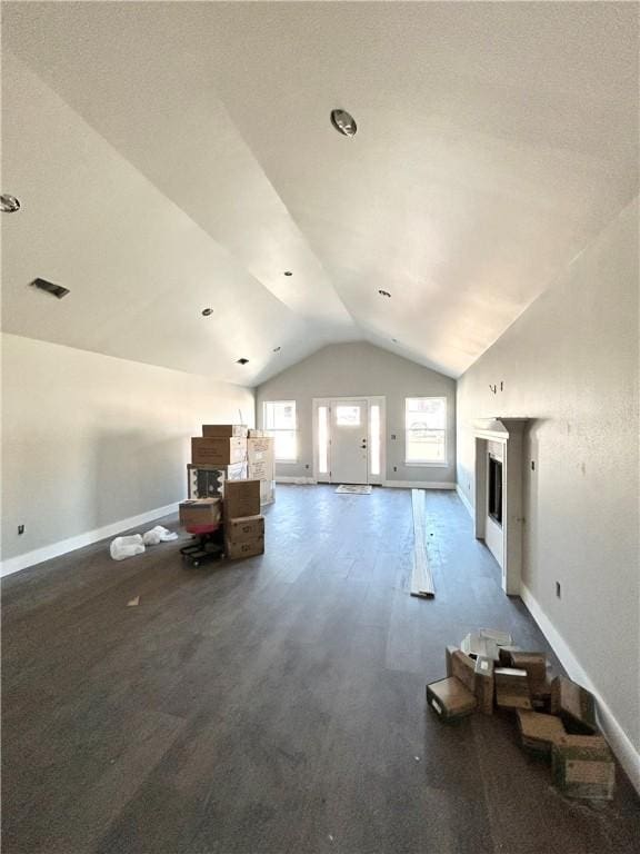 additional living space with lofted ceiling and a fireplace