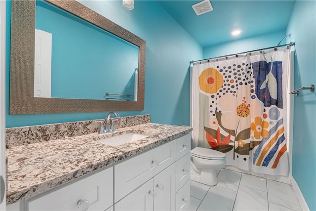 bathroom featuring toilet, vanity, and a shower with curtain