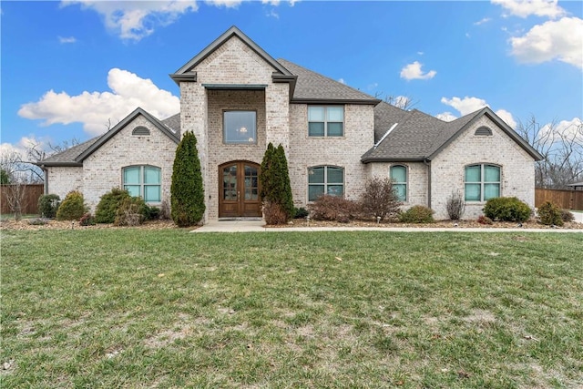 french provincial home featuring a front lawn and french doors