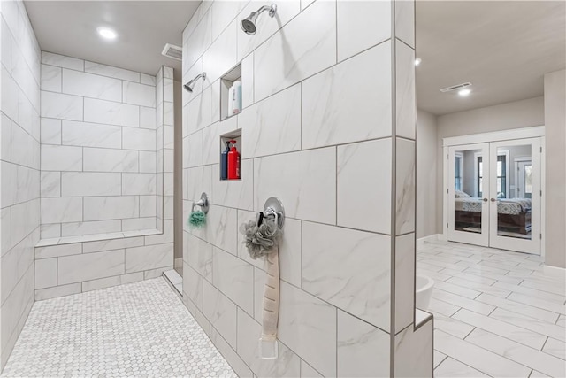 bathroom featuring tiled shower and french doors