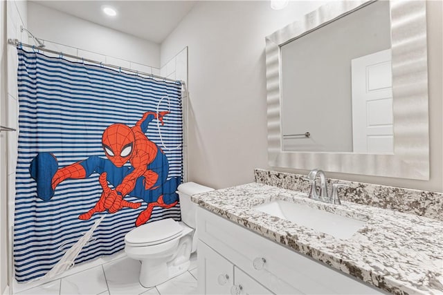 bathroom featuring toilet, vanity, and a shower with shower curtain