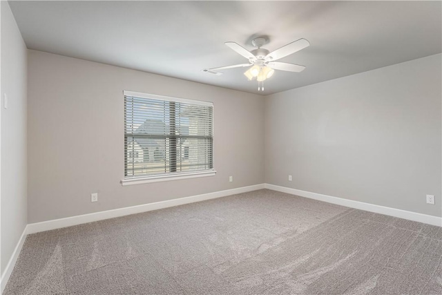 carpeted empty room featuring ceiling fan