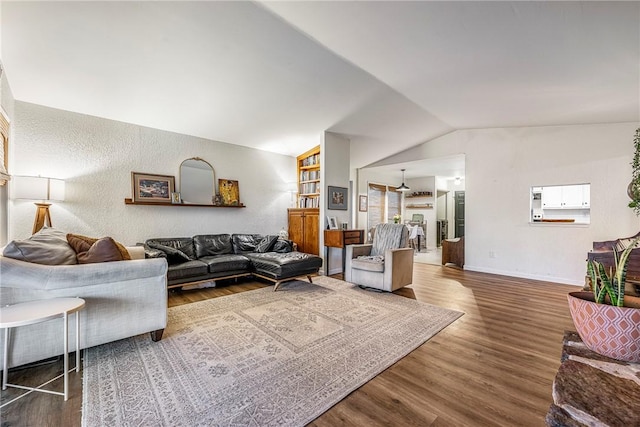 living room featuring vaulted ceiling and wood-type flooring