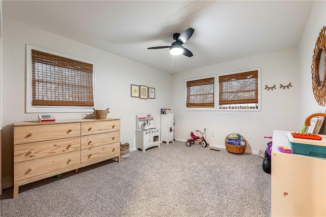 playroom featuring ceiling fan and carpet floors