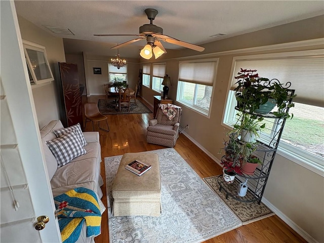 living room featuring ceiling fan, plenty of natural light, and hardwood / wood-style floors