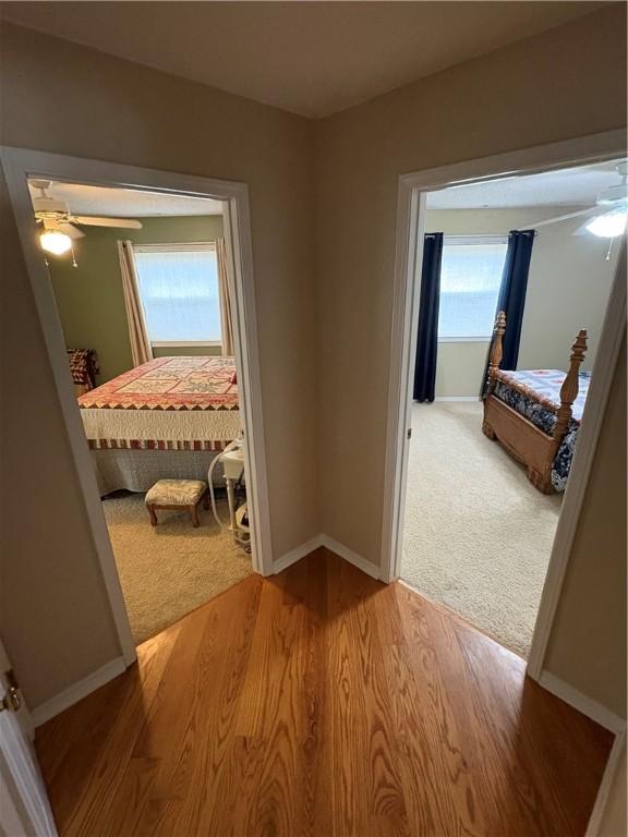 hallway with light hardwood / wood-style floors