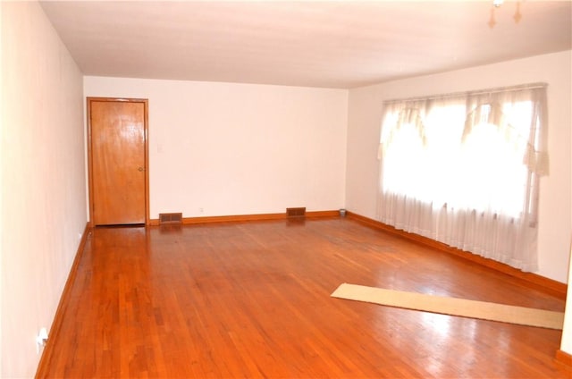 spare room featuring hardwood / wood-style flooring