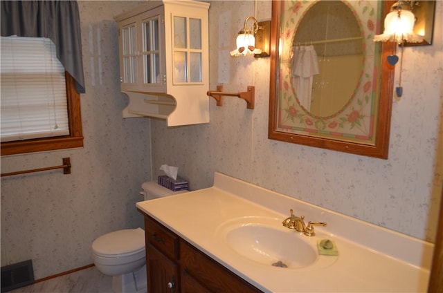 bathroom featuring toilet, a shower with shower curtain, and vanity