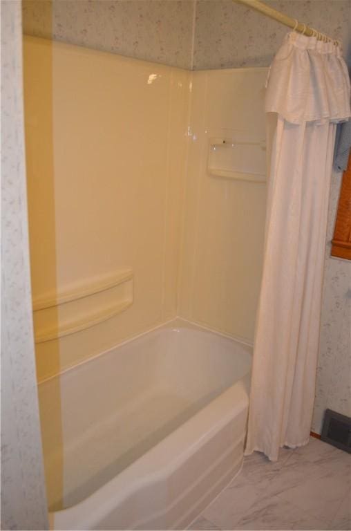 bathroom with shower / bath combo with shower curtain