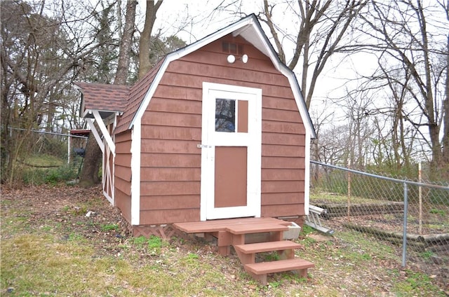 view of shed featuring fence