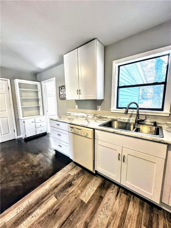 kitchen featuring dishwasher, a sink, white cabinetry, and dark wood-style floors