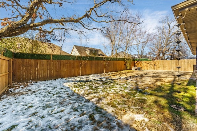 view of yard layered in snow