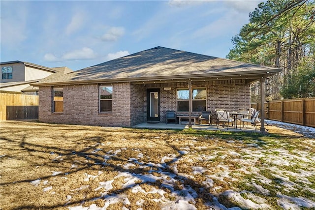 rear view of property with a patio area and a lawn